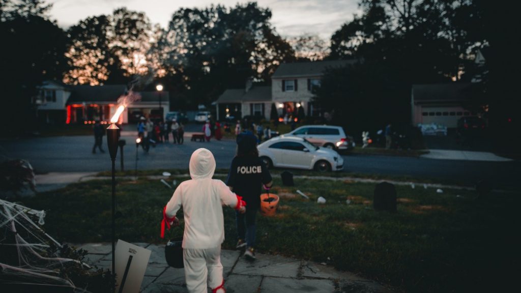 children trick or treating in a neighborhood