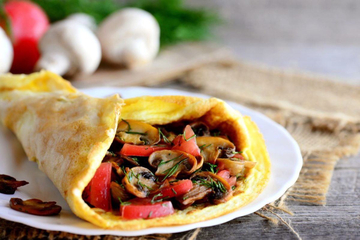 An omelet with mushrooms and red peppers. 