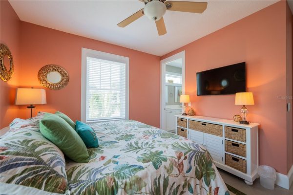 Coral-walled bedroom with a ceiling fan, tropical leaf quilt, and green/teal throw pillows.”] }? Wait format. Need array. Let's provide multiple strings.